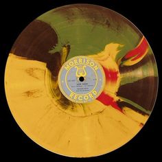 an old record that is yellow and green