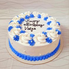 a birthday cake with blue and white frosting on it's side that says happy birthday vaga