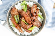 a bowl filled with meat and rice on top of a table