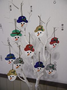 a snowman ornament hanging from a tree