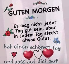 a white sign with red hearts and words written in german on the side of it