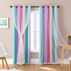 the curtains are hanging in front of the window with pink, blue and green drapes