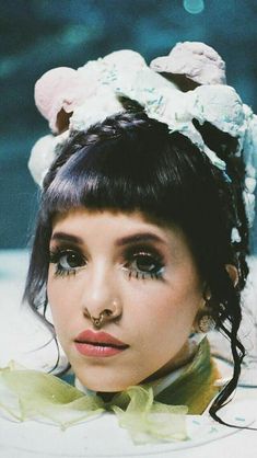 a young woman wearing a flowered headpiece