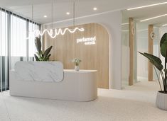 an office lobby with a marble counter and white walls