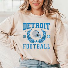 Show your pride with our Detroit vintage-style football sweatshirt.  Perfect for game day, this Lions Sunday football sweatshirt is a must-have for any fan. It's a stylish Detroit crewneck sweater that makes a great gift for any football enthusiast who supports the Detroit team. .: 50% cotton, 50% polyester .: Medium-heavy fabric (8.0 oz/yd² (271.25 g/m .: Loose fit .: Sewn-in label .: Runs true to size Sizing Details All sweatshirts are unisex and run true to size. Please refer to the sizing gu Fan Merchandise Team Colors Sweatshirt With Graphic Print, Football Season Game Day Crew Neck Sweatshirt, Game Day Football Season Crew Neck Sweatshirt, Team-colored Varsity Sweatshirt For Fans, College Football Season Sweatshirt With Team Name, College Football Season Graphic Print Sweatshirt, Team-colored Crew Neck Hoodie For Game Day, Football Season Team Logo Crew Neck Sweatshirt, Football Season Team Logo Cotton Sweatshirt