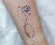 a small tattoo on the arm of a woman