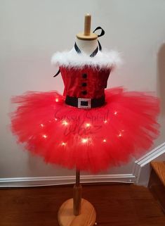 This tutu dress is handmade 100% . It features a stretchy red bodice with red velvet fabric. It comes with the white feathers perfect for holidays. It does come with lights that are hidden and can be turned on and off. A big bow in the back :) This is a great dress for the holidays, pageant or a birthday! Red Tutu Costume, Red Velvet Fabric, Pageant Wear, Christmas Tutu, Red Tutu, Market Ideas, Tutu Costumes, White Feathers, Big Bows