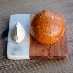 a loaf of bread sitting on top of a wooden cutting board