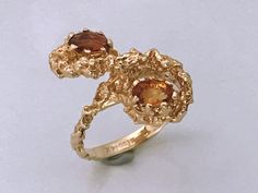 Rare Vintage 14kt Gold Brutalist Ring With Two Citrine Stones. Unique brutalist twist figure eight dome with two oval seated orange stones. Make a statement with this unique chunky piece of jewelry. Markings: SECO 14k Measurements: Ring Size 6, Stones- 5.4mm each Total Weight: 5.26 grams Condition: Great Vintage condition, ready to wear. Please review the photos for visual detail and let me know if you have any further questions prior to purchase. I don't offer returns or exchanges. USA sales on Unique Yellow Gold Topaz Ring For Formal Occasions, Gold Rings With Multi-stone Yellow Sapphire, Gold Yellow Sapphire Multi-stone Rings, Unique Gold Topaz Ring For Formal Occasions, Heirloom Yellow Gold Rings With Yellow Sapphire, Heirloom Yellow Gold Ring With Yellow Sapphire, Heirloom Yellow Sapphire Ring In Yellow Gold, Fine Jewelry 14k Yellow Gold Topaz Ring, Gold Topaz Ring With 17 Jewels In 14k Gold