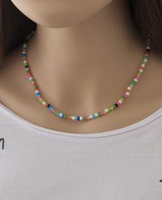 "The Dainty Colorful Beaded choker is great for summer and in the beach. It is made with small Japanese glass beads. This Beaded Choker can be perfect to wear everyday. This listing for ONE CHOKER. DETAILS - Japanese glass seed beads 4 mm - Quality strong nylon string - Choker length. Choose in the drop down menu - Lobster or round clasp closure. Available gold tone (default) or silver tone (by request) - Extension (adjustment) is 1 inch (2.5 cm). If you need longer, please, leave a note when or Colorful Beads Strand Necklaces, Trendy Tiny Beads Choker For Summer, Summer Beaded Chain Choker As Gift, Trendy Summer Round Beads Choker, Trendy Round Beads Choker For Festivals, Summer Beach Choker With Round Beads, Bohemian Strand Choker For Summer, Strand Beaded Necklaces For Festivals, Beaded Choker Necklace For Summer