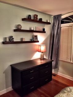 a bedroom with two shelves on the wall