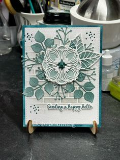 a close up of a card on a table with scissors and other crafting supplies