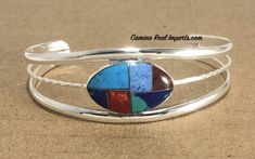 MULTI STONE INLAY BRACELET Adjustable Oval-shaped StoneMosaic Bracelet expertly hand madein Alpaca SilverMeasures: 2.5" X 1" This beautiful bracelet was handcrafted by women in Mexico with alpaca silver (size and color may vary) Stone Inlay, Stone Mosaic, Multi Stone, Beautiful Bracelet, Alpaca, Cuff Bracelets, Silver Bracelet, Mosaic, Hand Made