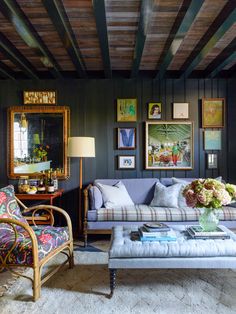 a living room filled with furniture and pictures on the wall