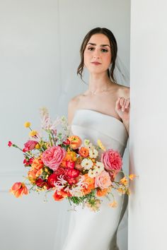 a woman in a white dress holding a bouquet of flowers