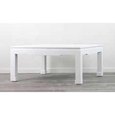 a white table sitting on top of a hard wood floor