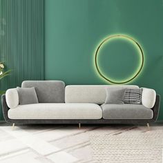 a modern living room with green walls and a white couch in front of the wall