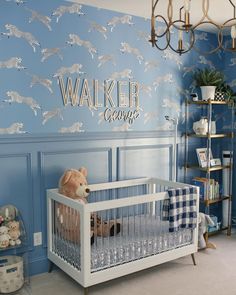 a baby's room decorated in blue and white with wallpaper that says walker going