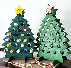 two wooden christmas trees with numbers on them