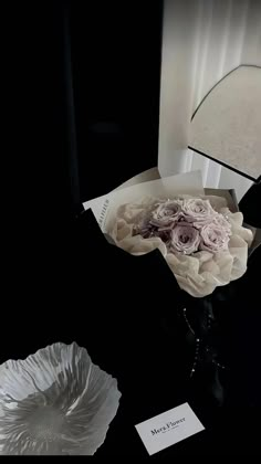 a bouquet of flowers sitting on top of a table next to a mirror and lamp