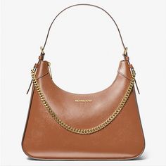 Michael Kors Wilma Large Luggage Smooth Leather Chain Shoulder Bag Introducing Wilma: A Sleek Shoulder Bag Made To Make A Statement. Featuring A Smooth Leather Exterior, It’s Cut In A Structured Silhouette And Features An Edgy Chain-Link Strap For Tough-Luxe Appeal. We Think It’s The Perfect Day-To-Night Bag 100% Leather From Tanneries Meeting The Highest Standards Of Environmental Performance Shoulder Bag Leather 100% Leather Gold-Tone Hardware 14.5”W X 12”H X 4”D Handle Drop: 11” Interior Deta Classic Leather Bag With Gold Chain, Designer Leather Bag With Gold Chain, Everyday Leather Shoulder Bag With Gold Chain, Everyday Leather Bags With Gold Chain, Leather Travel Bag With Chain Detail, Classic Travel Bags With Chain Detail, Designer Shoulder Bag With Chain For Travel, Elegant Brown Bag With Gold Chain, Designer Chain Shoulder Bag For Travel