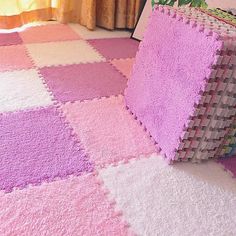 a pink and white rug is on the floor