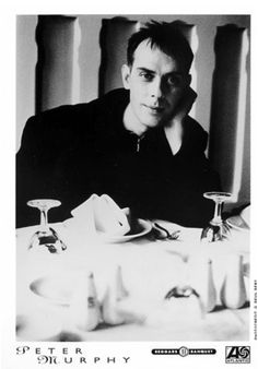 a black and white photo of a man sitting at a table