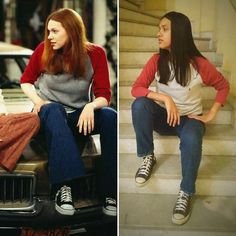 two women sitting on top of a car next to each other in front of stairs