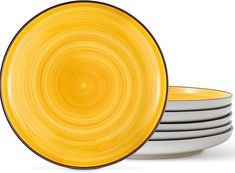 four yellow and white plates stacked on top of each other in front of a white background