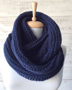 a blue knitted scarf on a mannequin