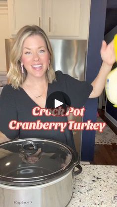 a woman holding a fish in front of a crock pot with the words crock pot cranberry turkey on it