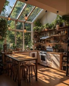 a kitchen filled with lots of windows next to a stove top oven and wooden table