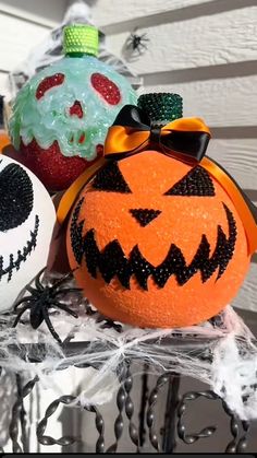 two pumpkins with faces painted on them sitting next to each other