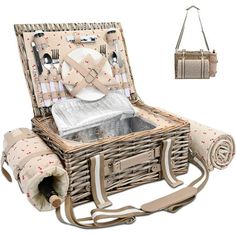 a wicker picnic basket with utensils and silverware in it, next to a handbag