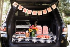 an open trunk with food and decorations on it