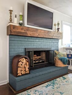 a living room with a fire place and television on top of the fireplace mantel