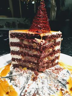 a large piece of cake on a plate with a christmas tree topper sitting on it