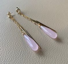 "Ear jacket rose quartz teardrop earrings. These one-of-a-kind multi gemstone earrings are definitely showstoppers! Gorgeous rose quartz smooth highly polished teardrops are floating off 14K gold filled chains. The gems are attached to small faceted crystal stones set in highly textured gold plated bezel and finished with sterling silver posts. Cool contemporary ear jacket are added to earrings creating a new look and giving you multiple options to mix and match . The ear jackets are  gold plated over brass ( led free).   The earrings with ear jackets are approximately 3\" long. The earrings are also available in silver finish.  * Every Raindrops jewelry purchase is packaged in a box made of kraft chipboard and covered with natural kraft paper.  A beautiful  finishing flair on your gift pu Bar Post, Teardrop Earrings Gold, Silver Bar Earrings, Droplet Earrings, Ear Jacket, Silver Bar, Earrings Ear, Crystal Stones, Dangly Earrings