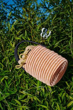 a small purse sitting on top of a lush green field