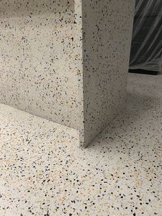 a bathroom counter with multicolored speckles on the top and bottom part