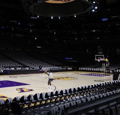 the basketball court is empty and ready to be played in an arena with fans watching