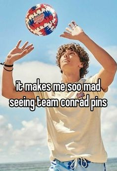 a young man is playing with a ball on the beach and it makes me so mad seeing team conrad pins