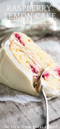 a piece of cake with white frosting and raspberries