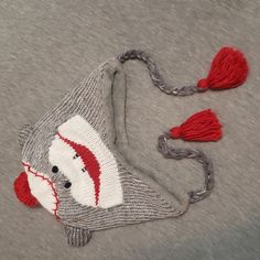 Unique!! Adorable Sock Monkey Pom Pom Beanie Trapper Cap :) Warm Pom Pom Topped Beanie Cap W/ Trapper Style Ear Flaps & Cute Tassled Strings To Tie Under The Chin Made Of Thickly Woven Sweater Fabric In Classic Sock Monkey Gray, White & Red :) Adorable Face W/ Red Woven Smile, Shiny Black Button Eyes & Little Puffy Ears Fully Lined W/ Super Soft Fleecey Fabric :) Would Be A Wonderful Gift!! :) No Labelled Size, But Material Is Stretchy, So It Can Fit Multiple Sizes (Approximate Measurements Show Sock Monkey Beanie, Sock Monkey Sweater, Beanie Earflap, Monkey Girl, Sweater Fabric, Button Eyes, Woven Sweater, Beanie Cap, Sock Monkey