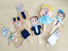 wooden clothes pins with cartoon characters on them sitting on a table next to other clothing pins