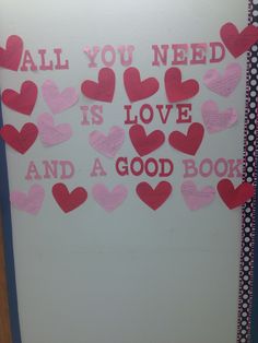 valentine's day bulletin board with pink and red heart cutouts on it, all you need is love and a good book