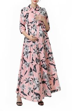 Tropical blooms in striking grey tones pop from the romantic pink backdrop of this long maternity shirtdress with a bump-flattering waist tie. The banded cuffs are softly gathered along with every tier down the skirt to give the effortless look flow and volume. 56" length Front button closure Spread collar Three-quarter sleeves Waist tie Tiered skirt Unlined 100% polyester Machine wash, tumble dry Imported Nursing Maxi Dress, Floral Dress Design, Button Front Maxi Dress, Pink Backdrop, Tiered Skirts, Maxi Shirts, Maxi Shirt Dress, Maternity Nursing, Pink Maxi Dress