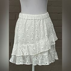 Pull On Style Elastic Stretch Waistband Floral Eyelet Tiered Design Fully Lined New !! Length 17” Waist 14” Across Flat White Tiered Skort, Cotton Tiered Skort With Lined Skirt, White Tiered Lined Skort, Short Length Ruffled Relaxed Skirt, Fitted Tiered Skirt Shorts For Spring, Spring Fitted Tiered Shorts, Flowy Tiered Lined Mini Skirt, Spring Tiered Mini Skirt With Lining, Spring Short Gathered Skirt