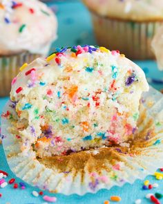 a cupcake with white frosting and sprinkles