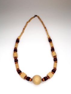 Vintage Hand Crafted Wooden Beaded Necklace with multi shades of tan and brown. Add some80's to your wardrobe. See images for full description. You will receive: (what you see in the images) - 1 Tan & Brown wooden necklace: 24" inches Contact me through Etsy messaging with any questions. All vintage items are hand picked for quality and uniqueness, so you can feel special wearing an authentic piece of the past. Thanks for shopping at Rose & Lily's, check back often for new vintage treasures. Handmade Retro Brown Necklaces, Retro Brown Handmade Necklaces, Retro Handmade Brown Necklaces, Vintage Brown Beaded Necklaces With Colorful Beads, Retro Brown Beaded Jewelry, Vintage Brown Wooden Bead Necklaces, Vintage Beige Round Beads Necklace, Vintage Beige Beaded Necklace, Vintage Brown Beaded Necklace With Wooden Beads